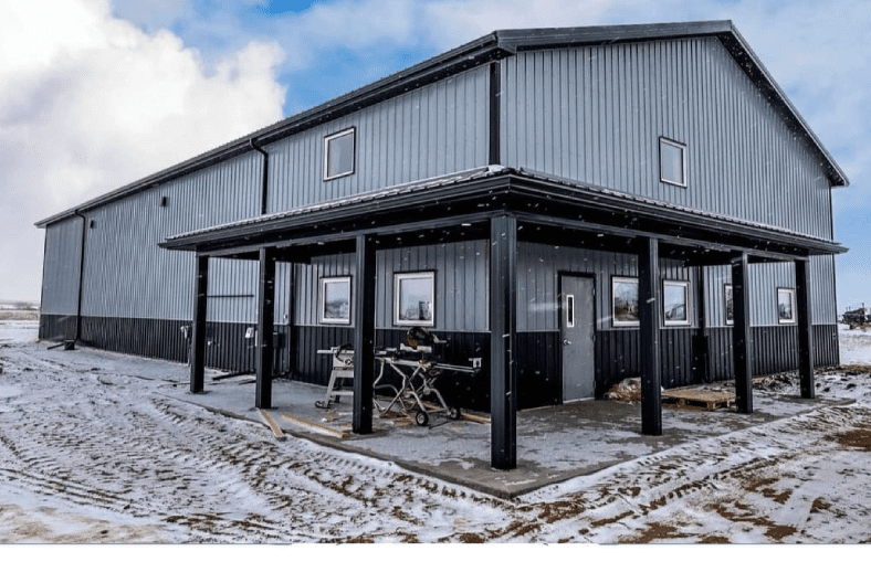 a large warehouse with snow on the ground